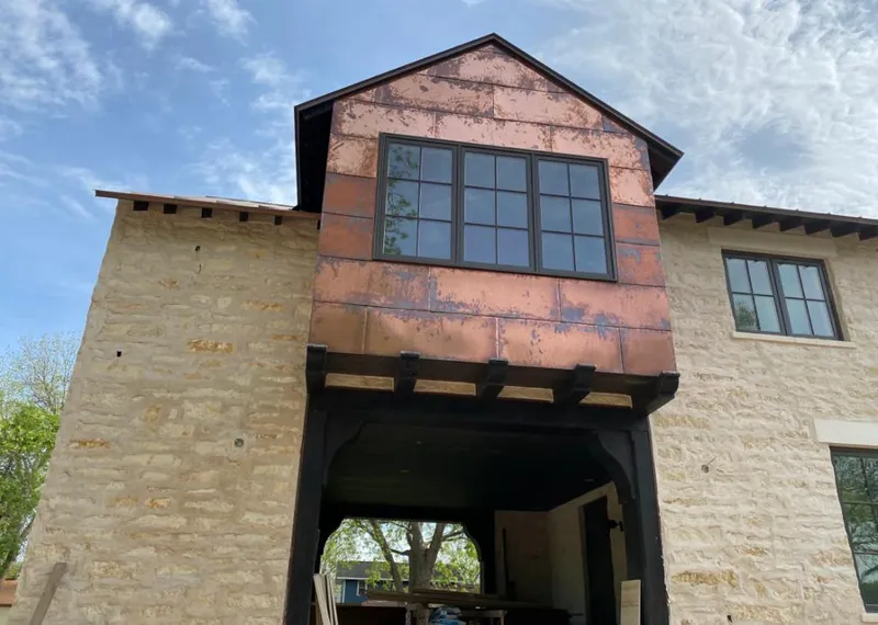 Copper metal panel facade on a stone building for Roof Repair in Steiner Ranch